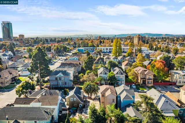 a front view of a building with street view and trees
