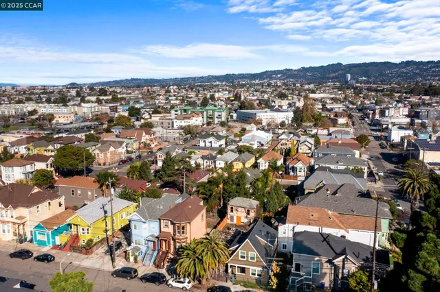 an aerial view of residential houses with city view