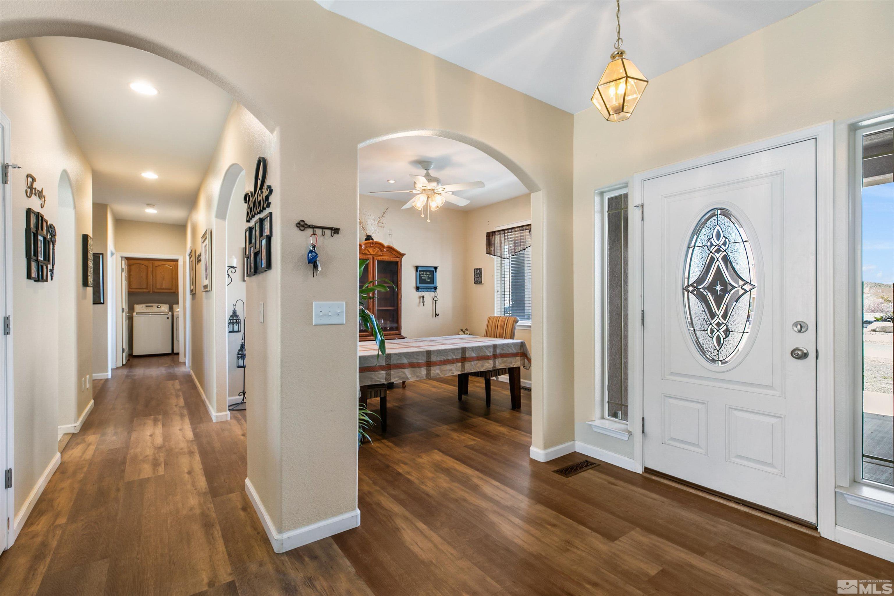 1095 Sage Street Fernley, NV 89408 - Photo 12 of 37 a view of a hallway to a livingroom with furniture and wooden floor