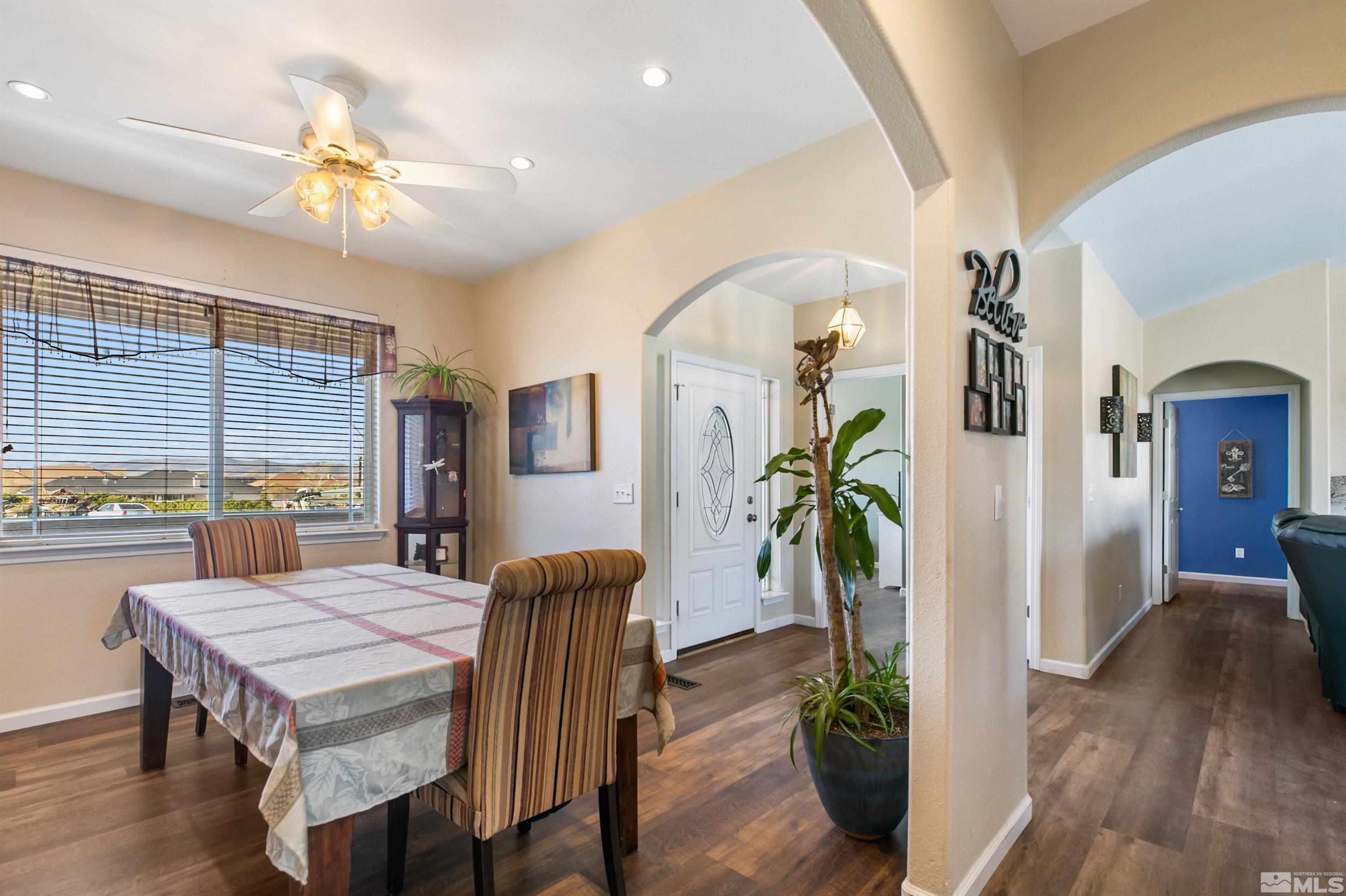 1095 Sage Street Fernley, NV 89408 - Photo 13 of 37 a view of a dining room with furniture window and wooden floor