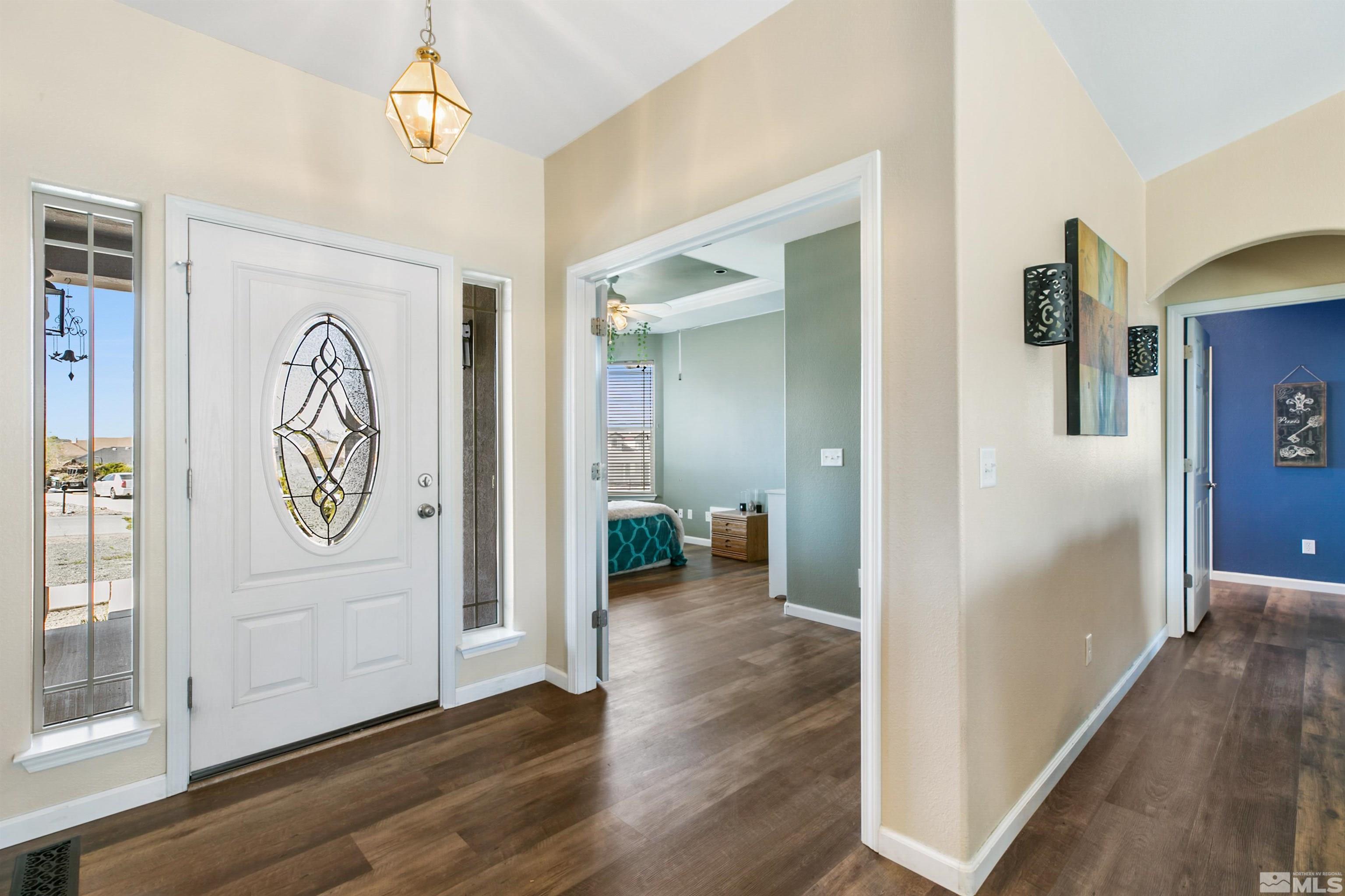 1095 Sage Street Fernley, NV 89408 - Photo 14 of 37 a view of a hallway with wooden floor