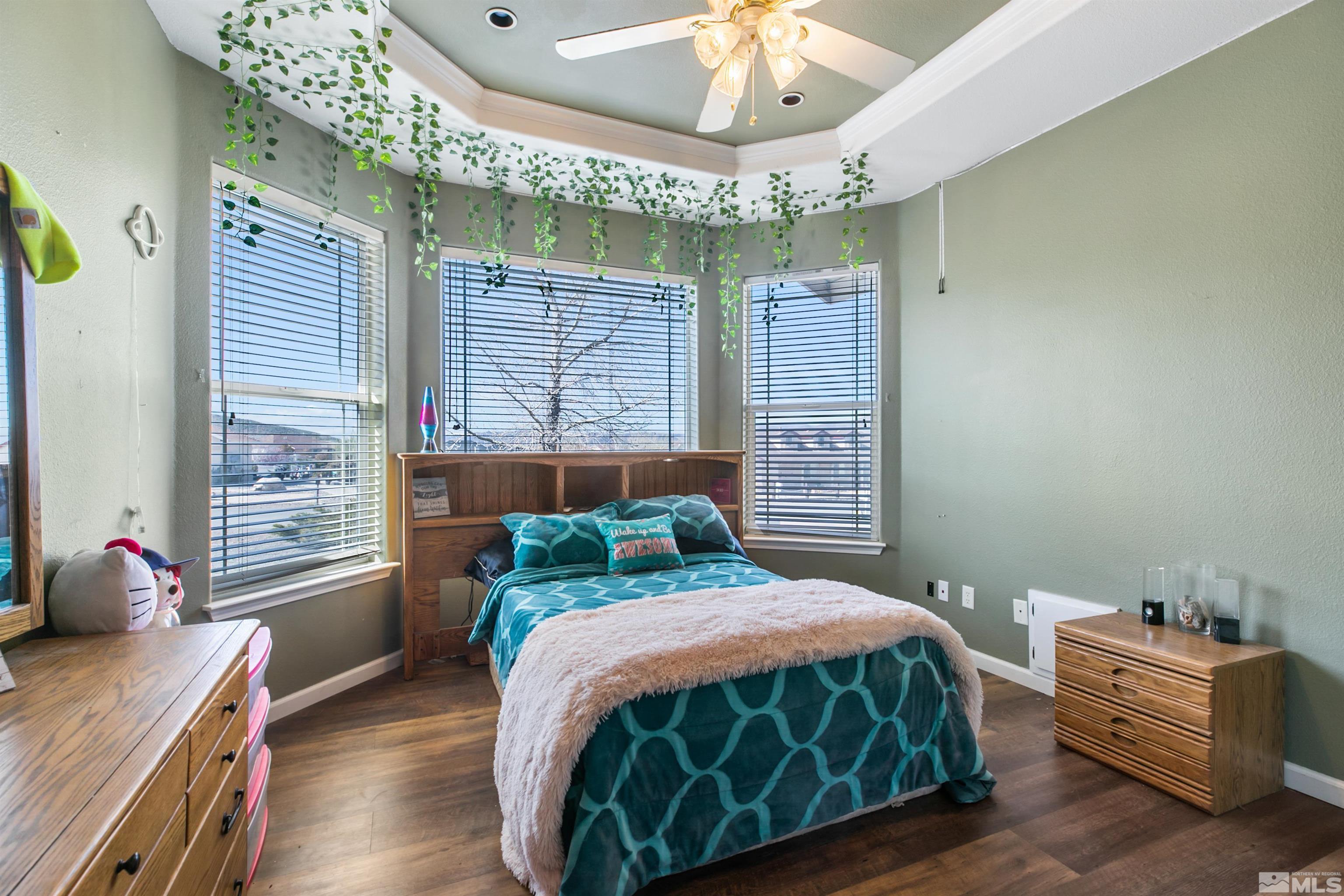 1095 Sage Street Fernley, NV 89408 - Photo 15 of 37 a bedroom with a bed and a chandelier