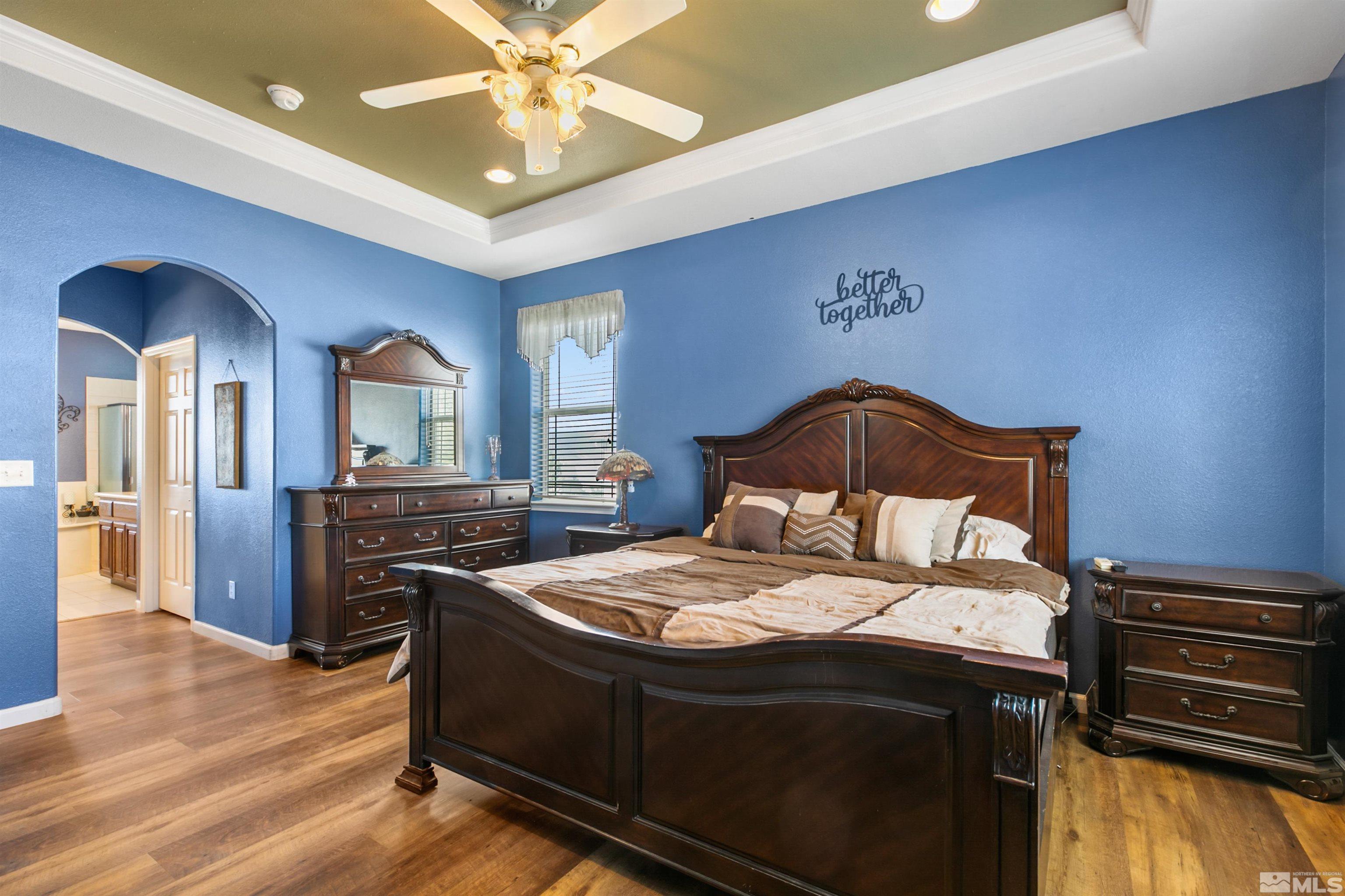 1095 Sage Street Fernley, NV 89408 - Photo 17 of 37 a bedroom with a bed and a chandelier