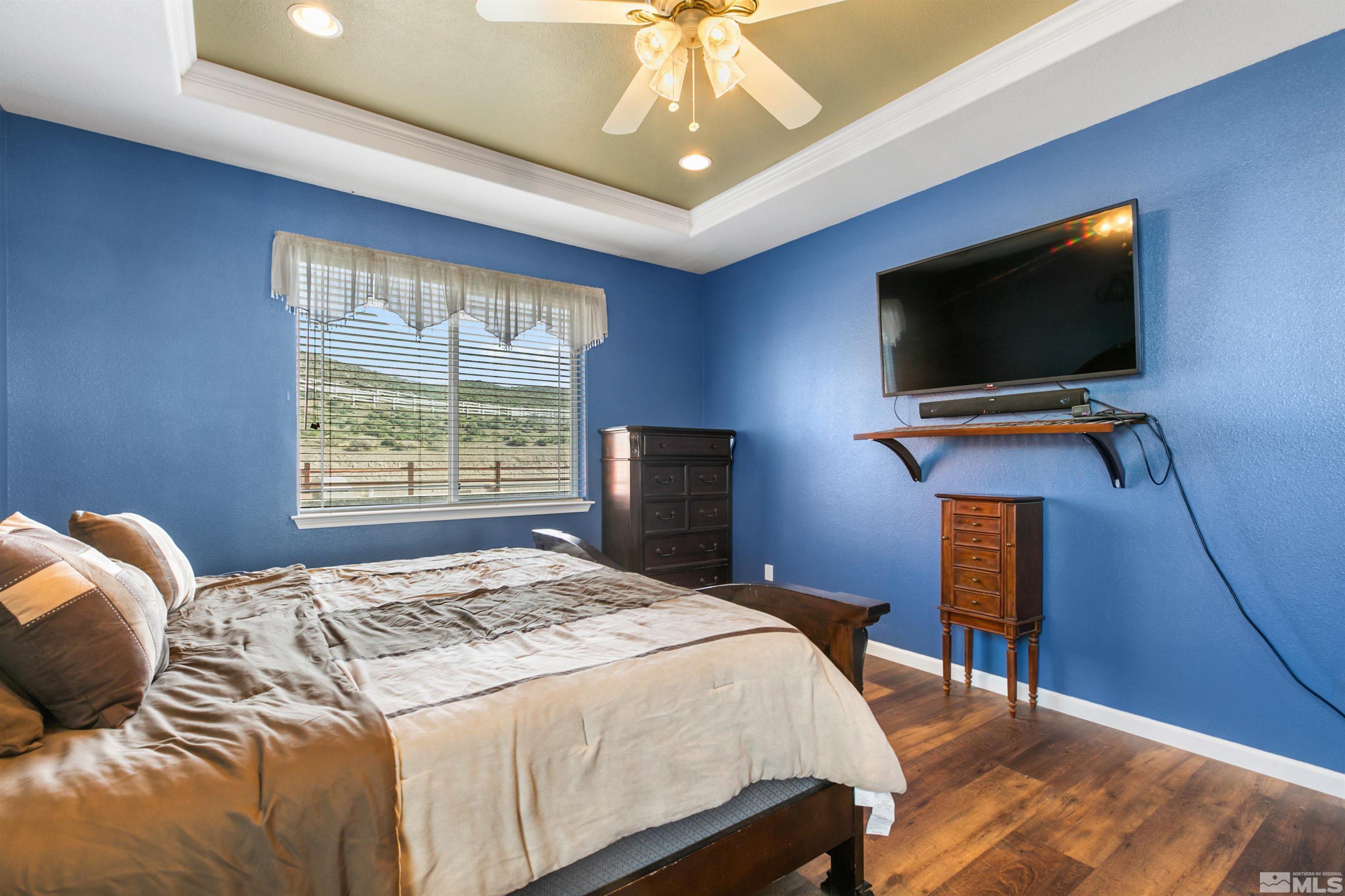 1095 Sage Street Fernley, NV 89408 - Photo 18 of 37 a bedroom with a bed and a flat screen tv