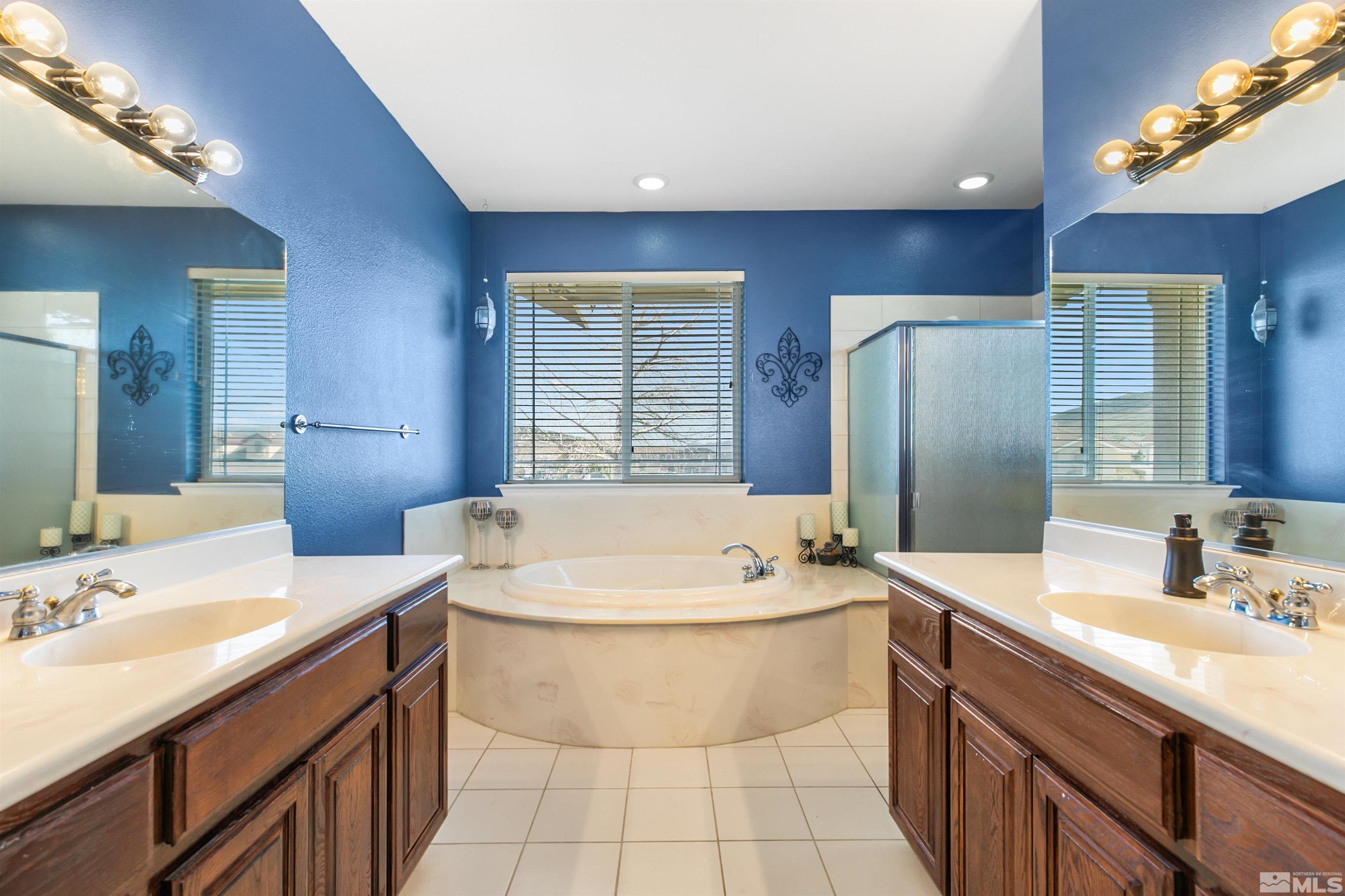 1095 Sage Street Fernley, NV 89408 - Photo 20 of 37 a bathroom with a tub sink and mirror