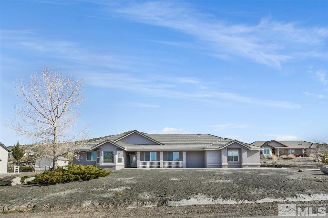 1095 Sage Street Fernley, NV 89408 - Photo 2 of 37 a front view of a house with a yard