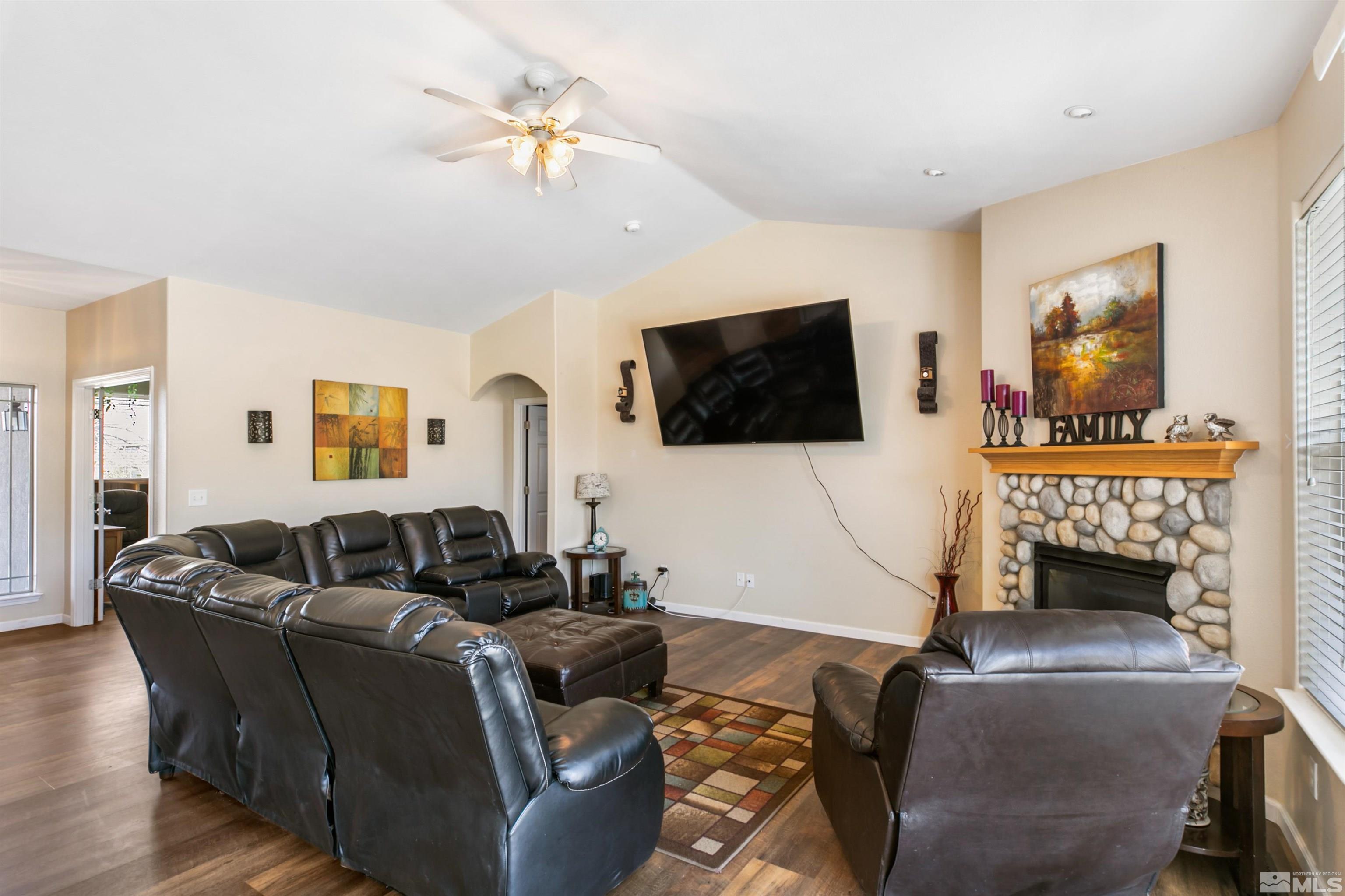 1095 Sage Street Fernley, NV 89408 - Photo 22 of 37 a living room with furniture a flat screen tv and a fireplace