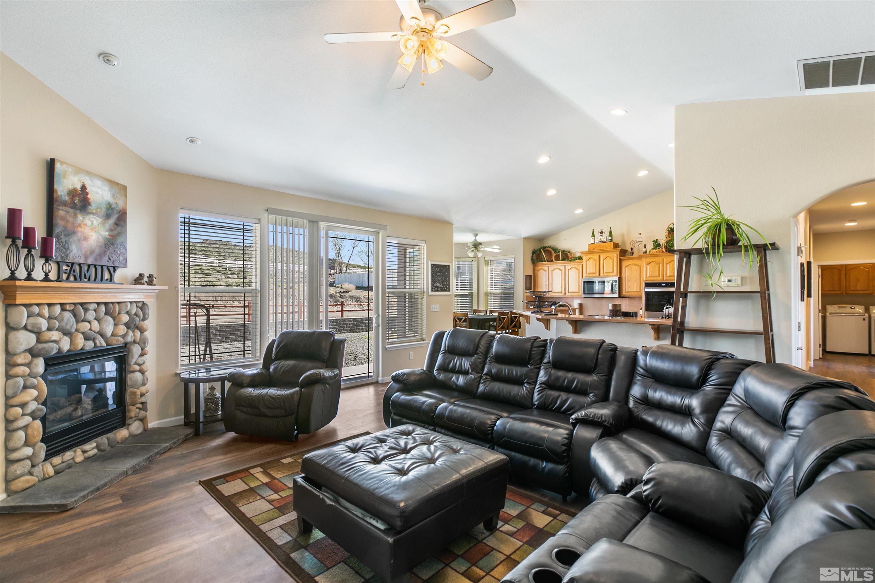 1095 Sage Street Fernley, NV 89408 - Photo 23 of 37 a living room with furniture a fireplace and a floor to ceiling window
