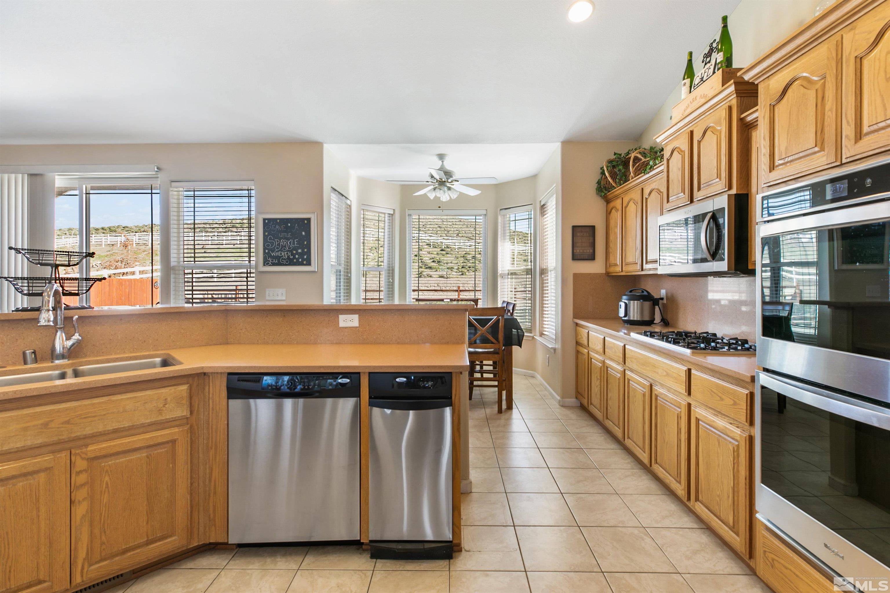 1095 Sage Street Fernley, NV 89408 - Photo 25 of 37 a large kitchen with cabinets and wooden floor