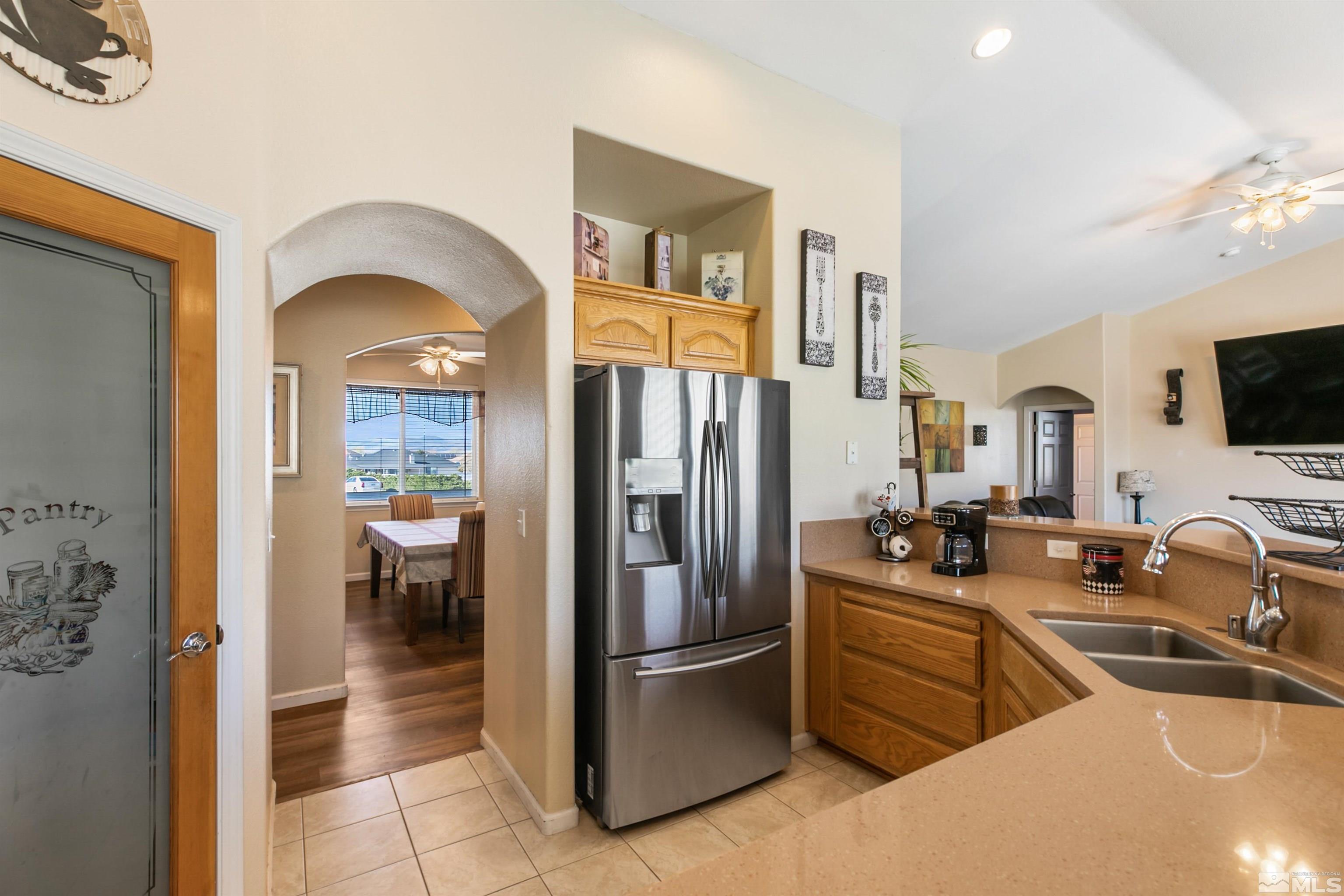 1095 Sage Street Fernley, NV 89408 - Photo 27 of 37 a kitchen with stainless steel appliances a refrigerator and a sink