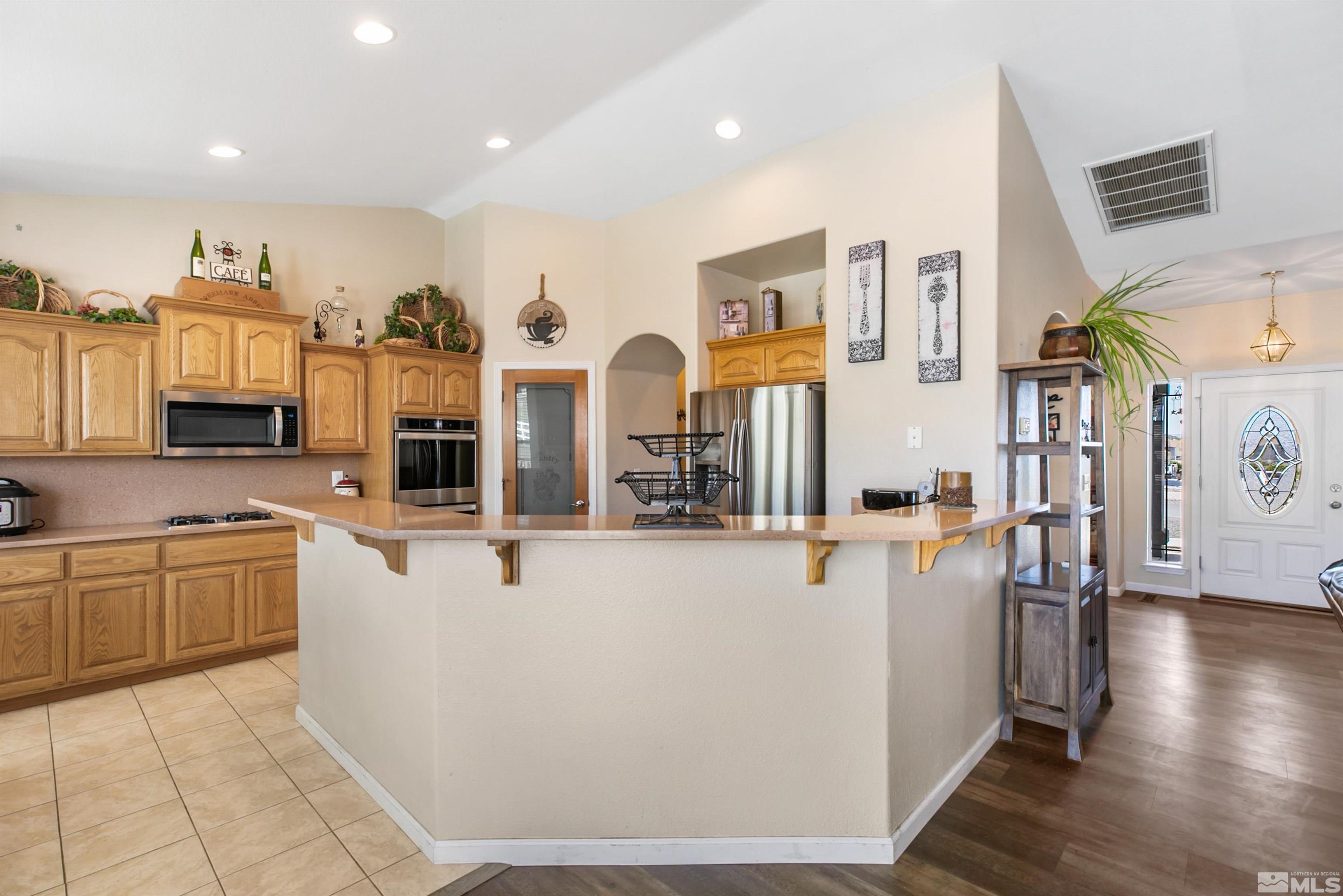 1095 Sage Street Fernley, NV 89408 - Photo 28 of 37 a view of a kitchen with furniture and wooden floor