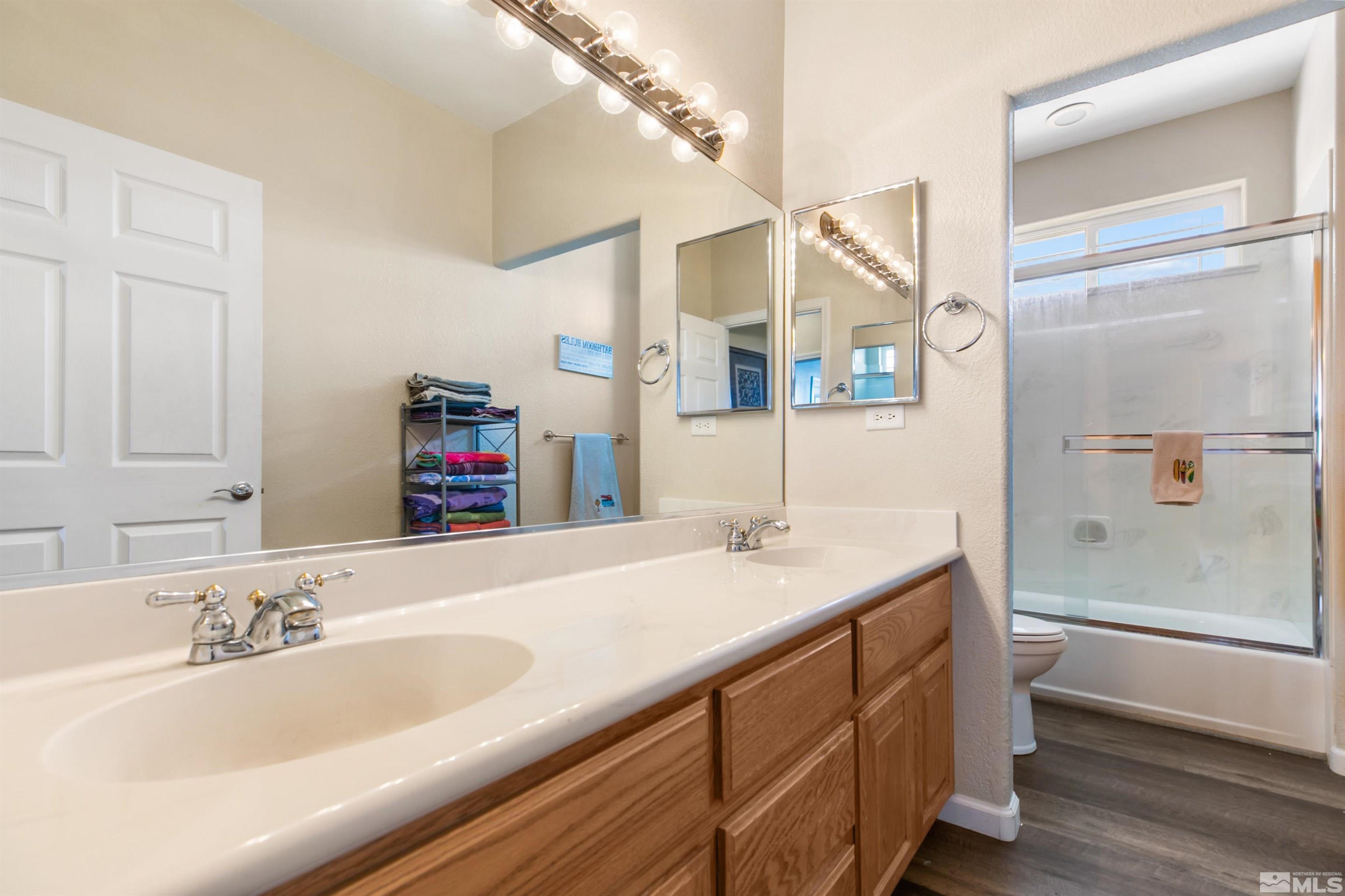 1095 Sage Street Fernley, NV 89408 - Photo 34 of 37 a bathroom with a sink and a mirror