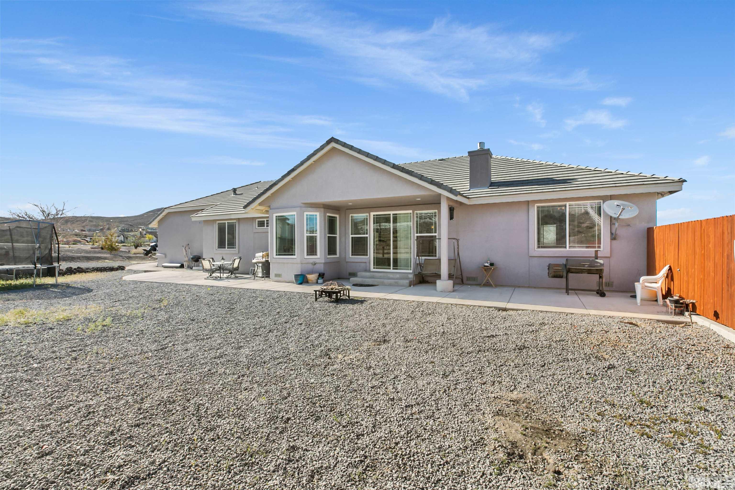 1095 Sage Street Fernley, NV 89408 - Photo 4 of 37 a front view of a house with a yard