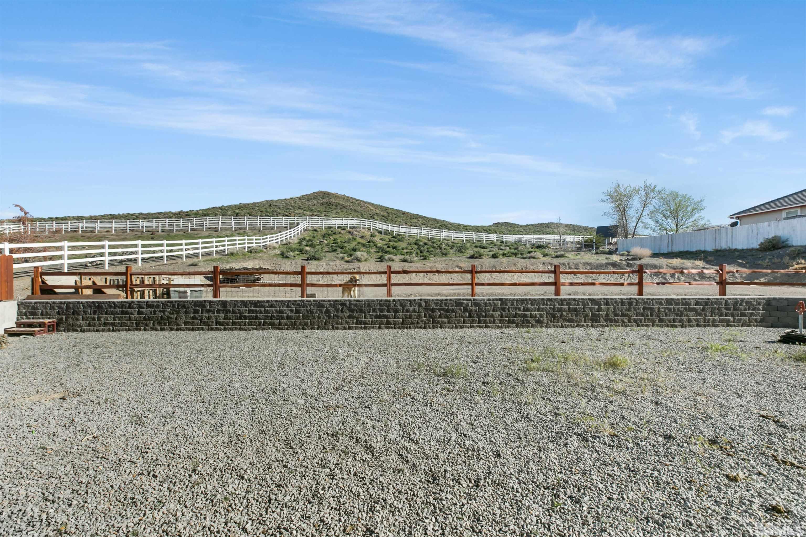 1095 Sage Street Fernley, NV 89408 - Photo 7 of 37 a view of a yard with an ocean view