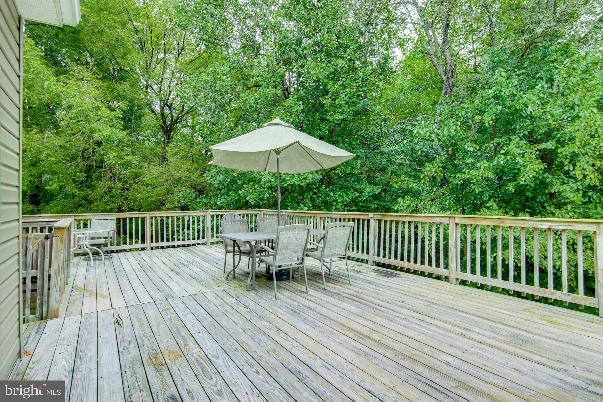 8640 Willow Run Road Windsor Mill, MD 21244 - Photo 16 of 37 Expansive Deck with stairs to stone Patio