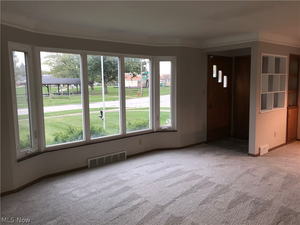6564 Ridgewood Lakes Drive Parma, OH 44129 - Photo 9 of 33 Living room with dining area to the right and built-ins. Newer windows throughout.
