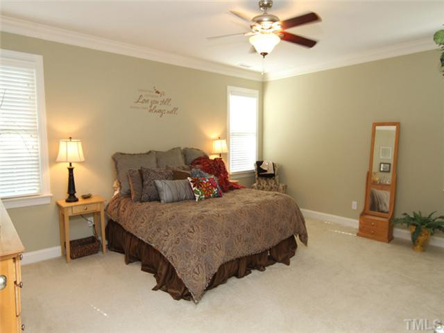 7305 Sparhawk Road Wake Forest, NC 27587 - Photo 10 of 25 OWNERS SUITE IS VERY LARGE AND BOASTS SITTING AREA AND SEVERAL CUSTOM FEATURES. LUXURY BATH AND VERY LARGE WALK-IN CLOSETS WITH "HIS AND HERS" SIDE AND ROWS OF CUSTOM SHELVING FOR YOUR ENTIRE WARDROBE. Master Suite