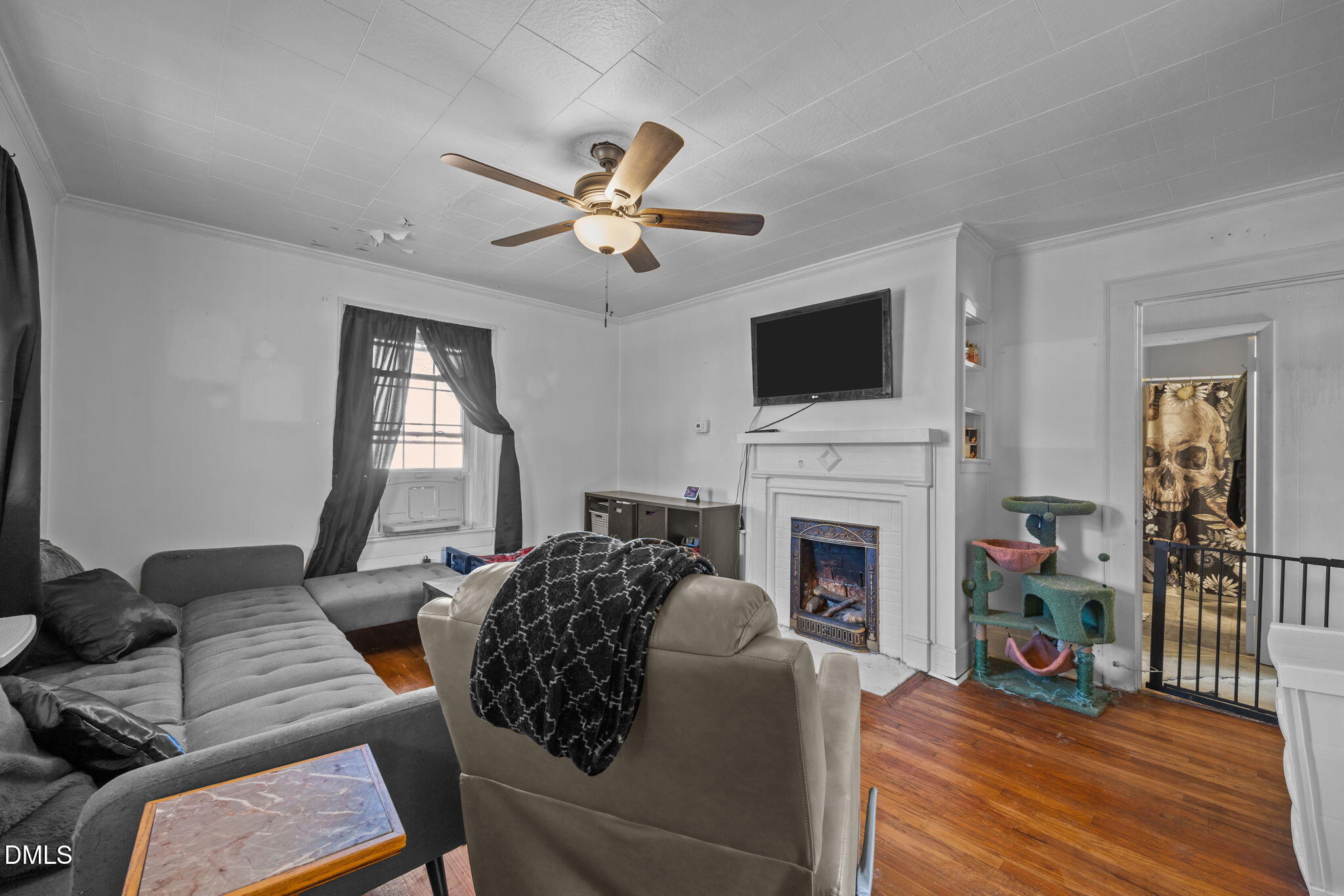 1713 Lower Hopedale Road Burlington, NC 27217 - Photo 4 of 13 a living room with furniture a fireplace and a flat screen tv