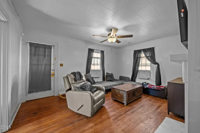 a living room with furniture and two window