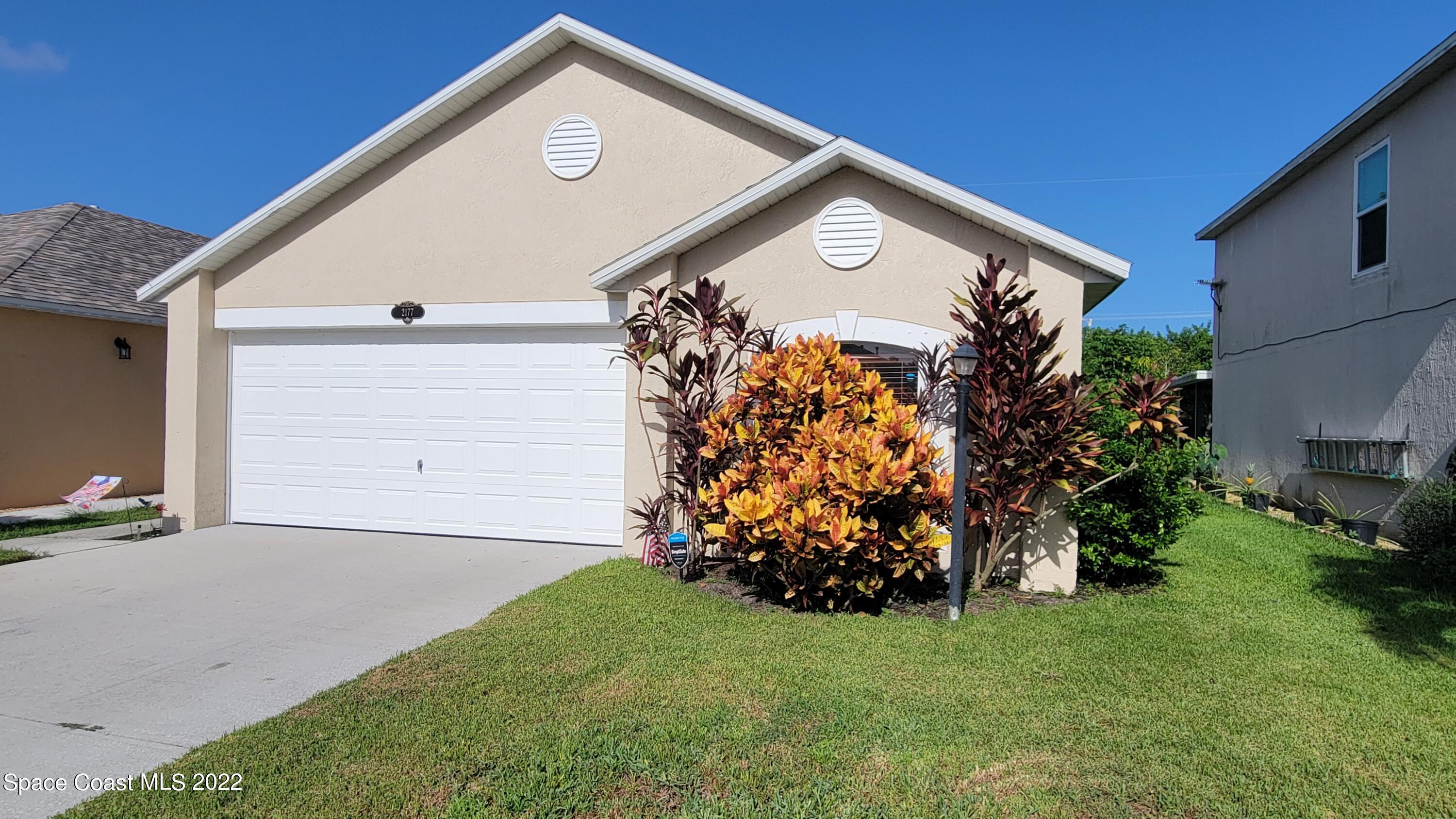 2177 Redwood Circle Palm Bay, FL 32905 - Photo 1 of 30 a view of a house with a yard