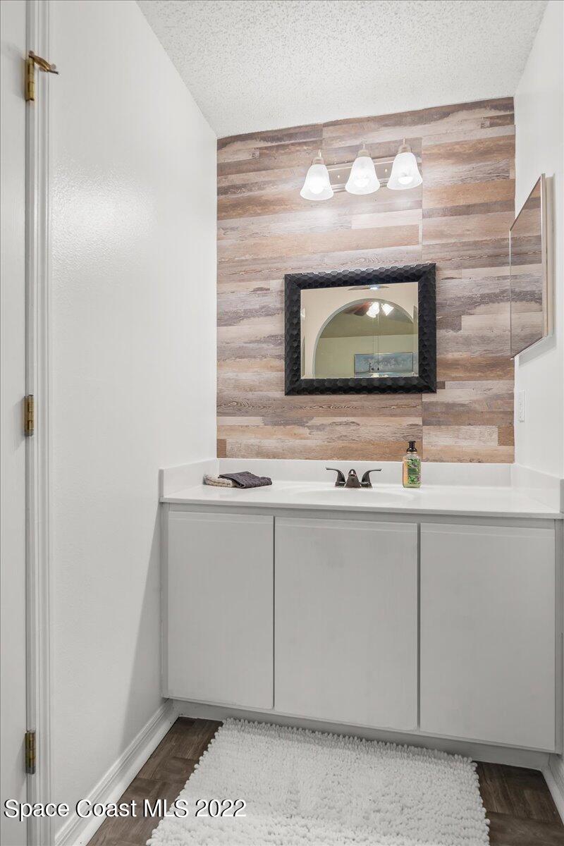 2177 Redwood Circle Palm Bay, FL 32905 - Photo 16 of 30 a bathroom with a sink and a mirror