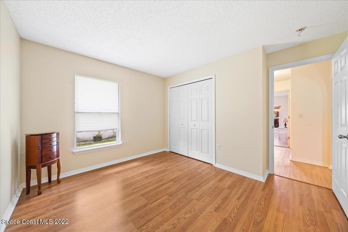 2177 Redwood Circle Palm Bay, FL 32905 - Photo 18 of 30 a view of an empty room with wooden floor and a window