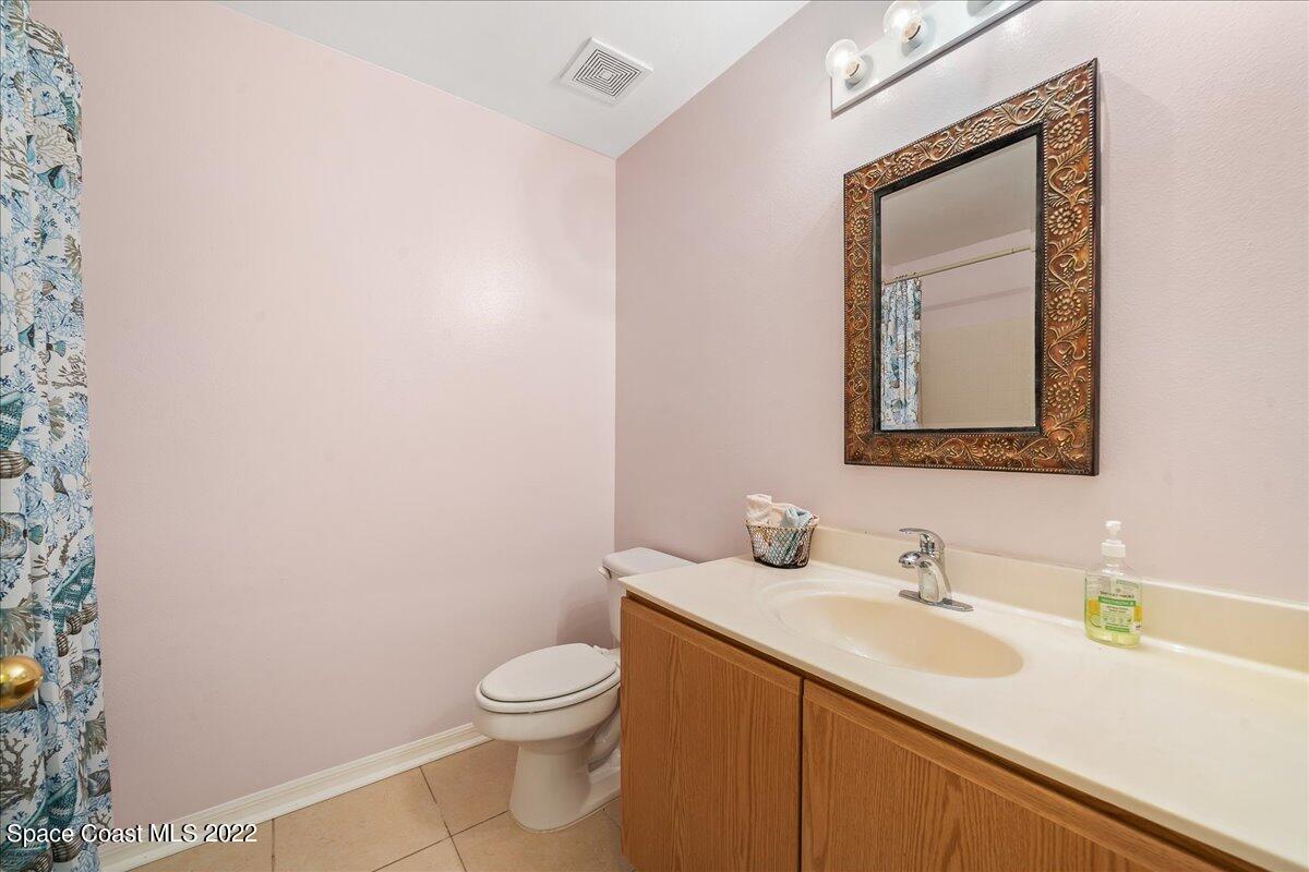 2177 Redwood Circle Palm Bay, FL 32905 - Photo 19 of 30 a bathroom with a toilet sink and mirror