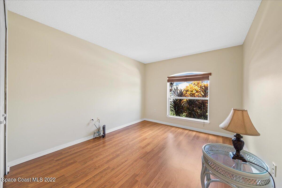 2177 Redwood Circle Palm Bay, FL 32905 - Photo 21 of 30 a view of an empty room with window and wooden floor