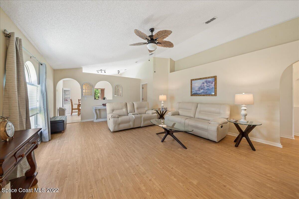 2177 Redwood Circle Palm Bay, FL 32905 - Photo 4 of 30 a living room with furniture and a chandelier