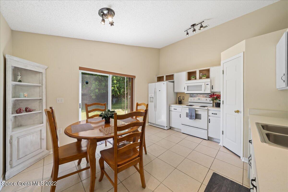 2177 Redwood Circle Palm Bay, FL 32905 - Photo 9 of 30 a dining room with furniture and kitchen view