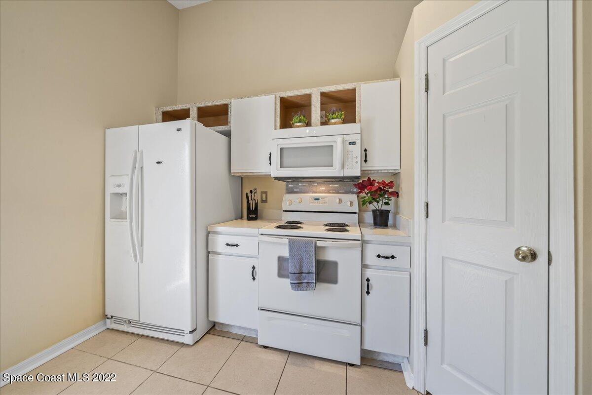 2177 Redwood Circle Palm Bay, FL 32905 - Photo 10 of 30 a kitchen with a stove and a refrigerator