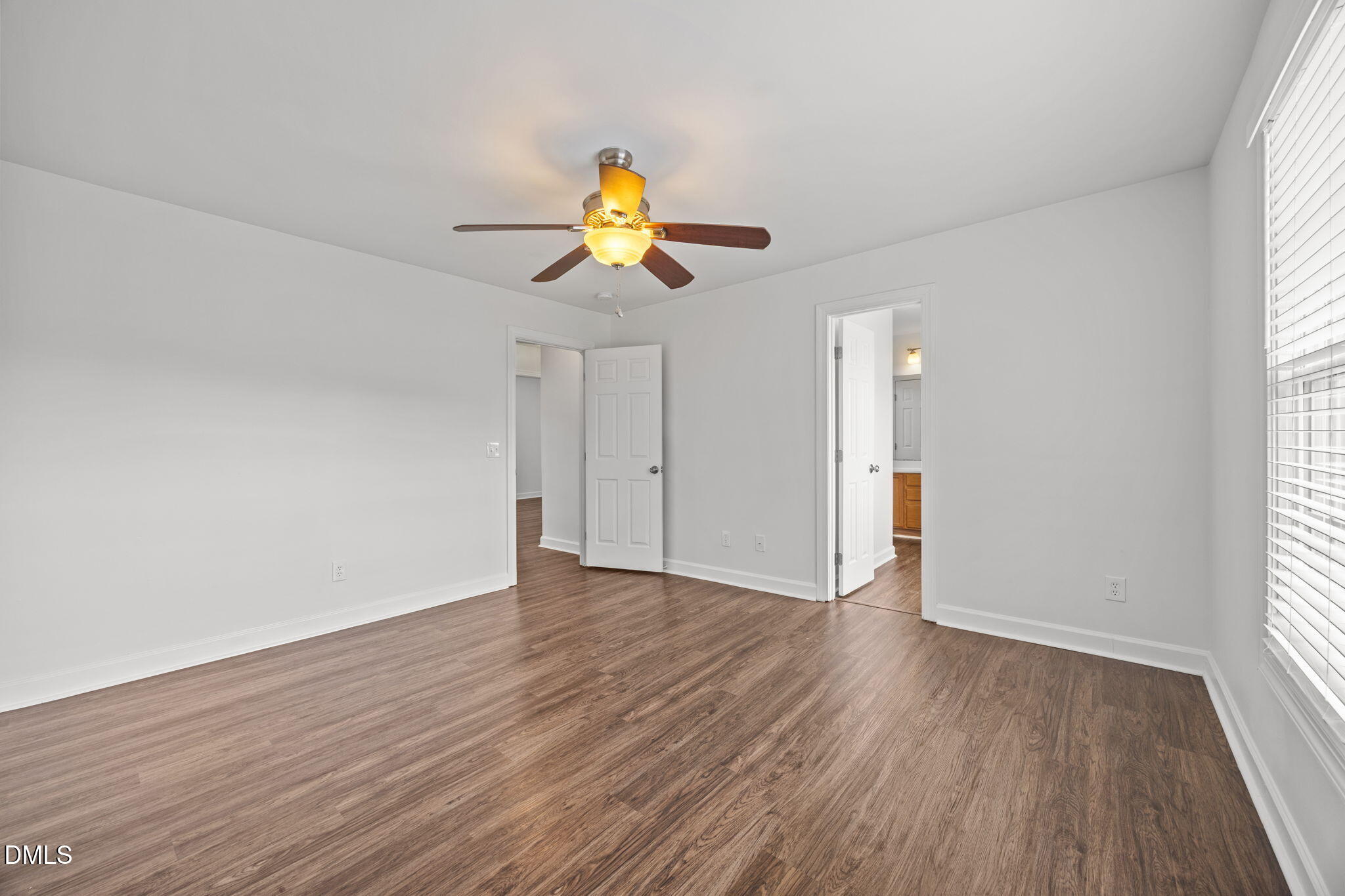 9220 Pennythorne Court Raleigh, NC 27615 - Photo 28 of 49 a view of an empty room with wooden floor and a window