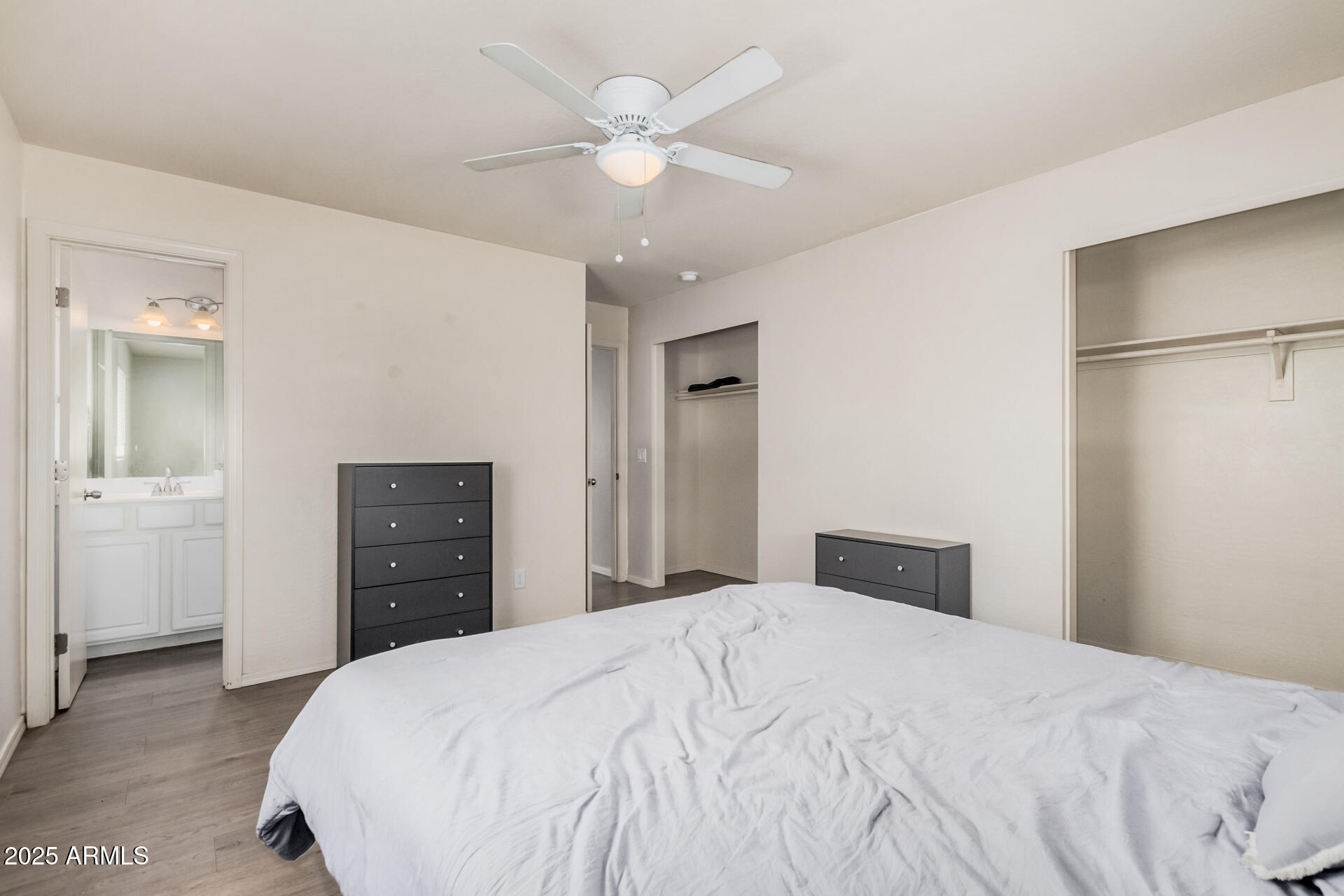 5533 East Decatur Street Mesa, AZ 85205 - Photo 11 of 29 a bedroom with a bed and a chandelier