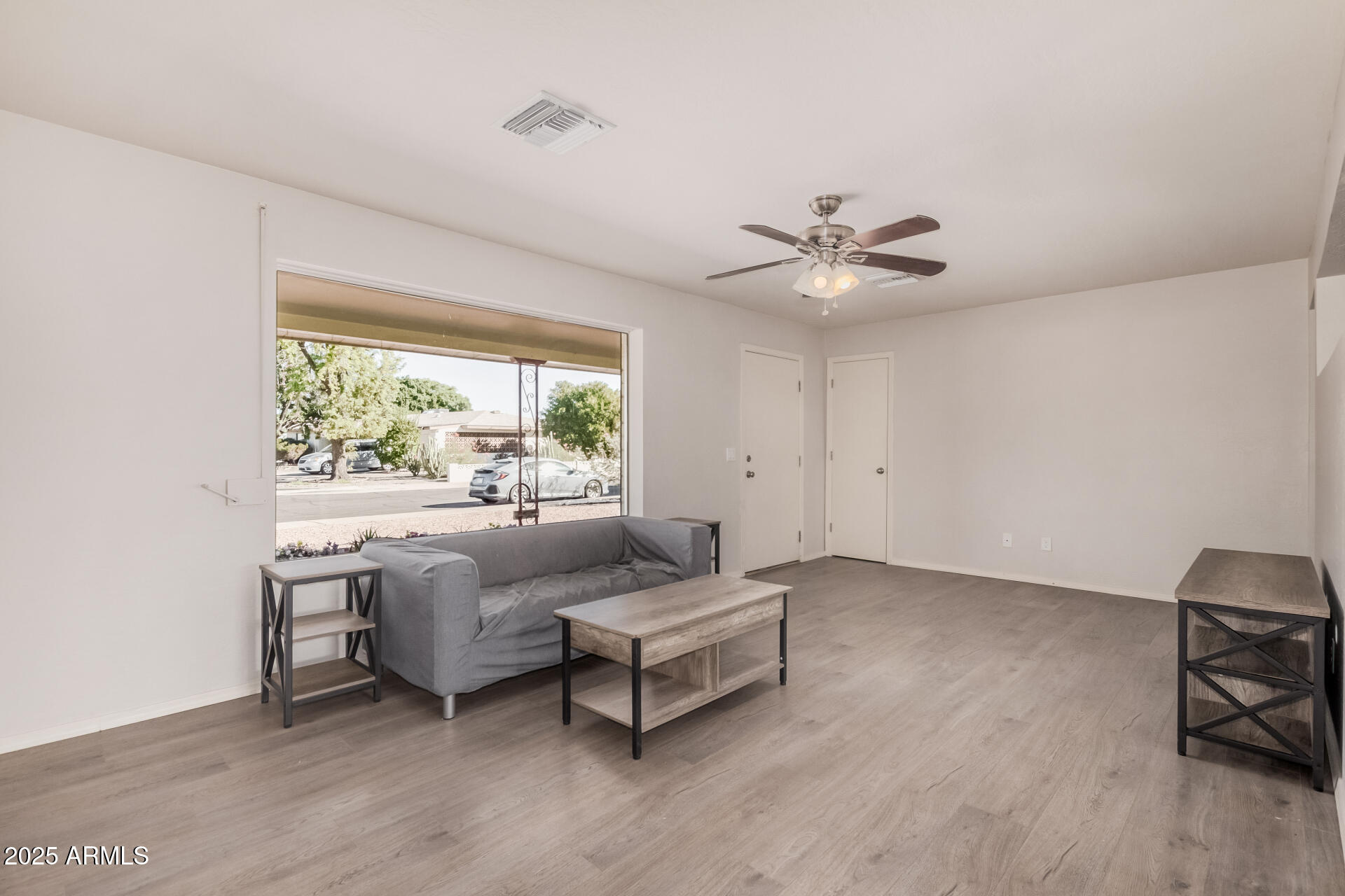 5533 East Decatur Street Mesa, AZ 85205 - Photo 6 of 29 a living room with furniture and a large window with wooden floor