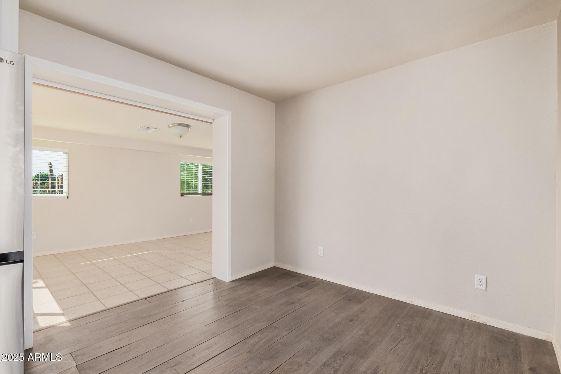 5533 East Decatur Street Mesa, AZ 85205 - Photo 7 of 29 an empty room with wooden floor and windows