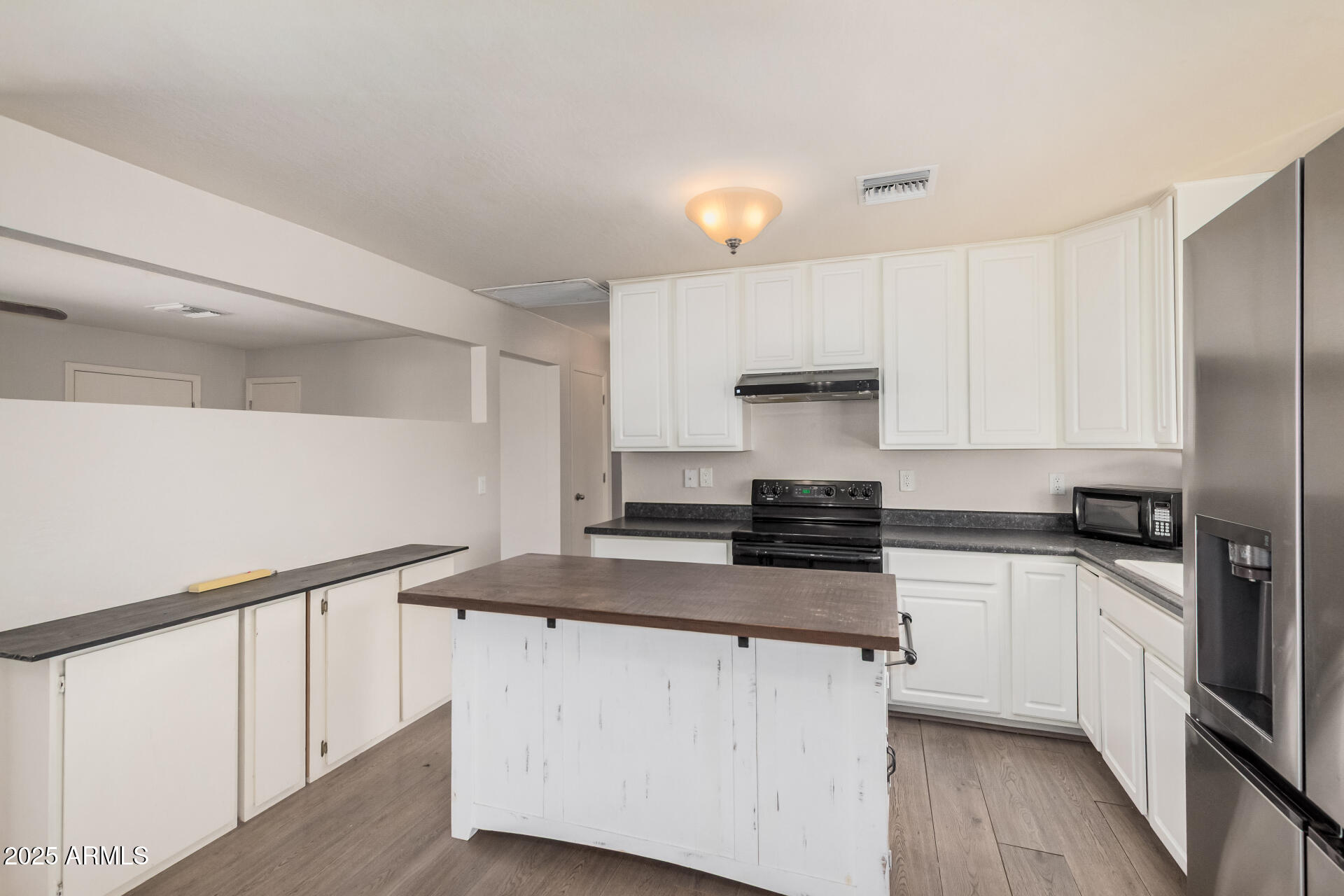 5533 East Decatur Street Mesa, AZ 85205 - Photo 8 of 29 a kitchen with stainless steel appliances granite countertop a stove a sink and a refrigerator