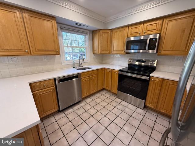 3409 Beret Lane Silver Spring, MD 20906 - Photo 5 of 18 a kitchen with a sink a stove top oven a refrigerator cabinets and a window