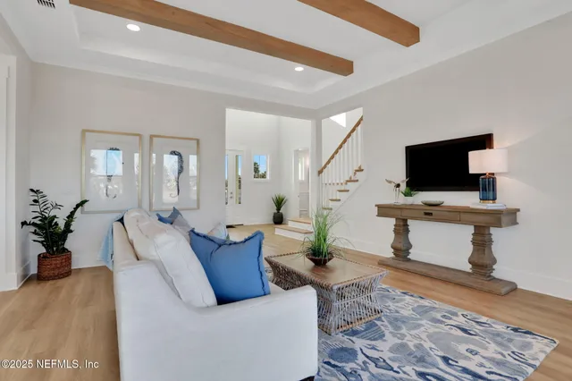 a kitchen with a stove a sink and a wooden floor
