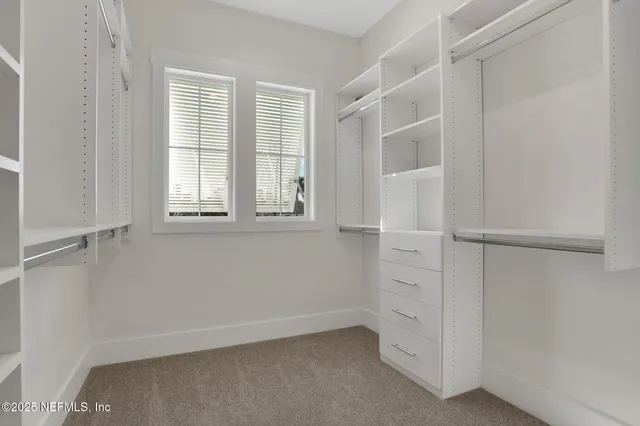 a en suite bathroom with double sink and mirror