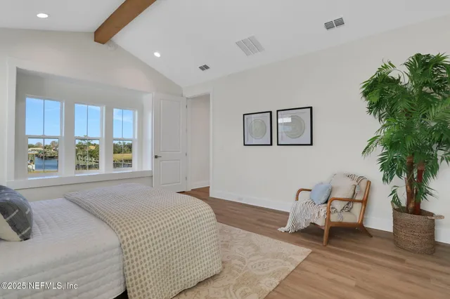 a living room with furniture and large windows