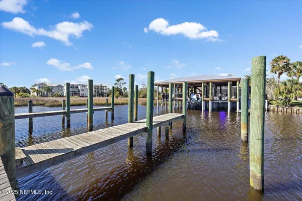 a living room with furniture large window and wooden floor