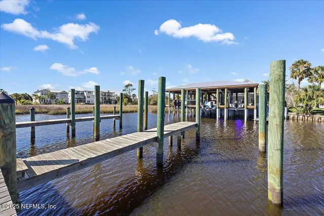 a living room with furniture large window and wooden floor
