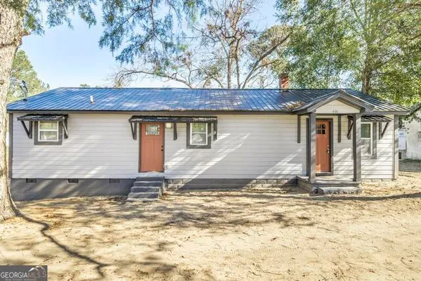a house with trees in the background