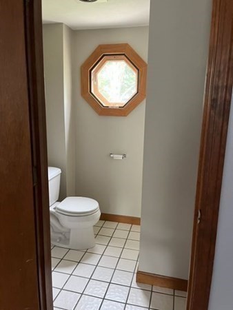 656 Franklin Street, Unit 656 Wrentham, MA 02093 - Photo 9 of 11 a bathroom with a toilet and a vanity