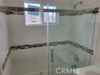 a bathroom with a glass shower door
