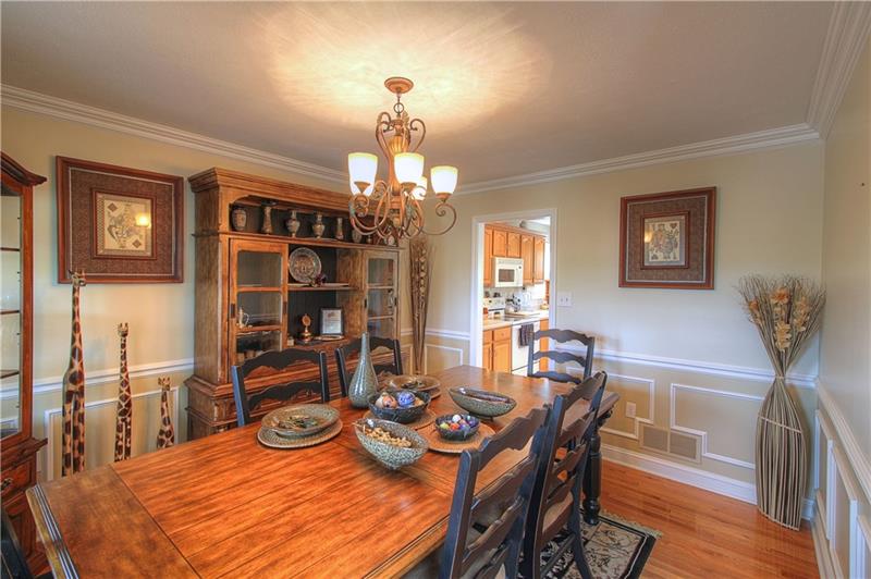 108 Chestnut Ridge Drive Beaver Falls, PA 15010 - Photo 3 of 25 Formal Dining Room features custom trim, chair rail and crown molding and hardwood floors.