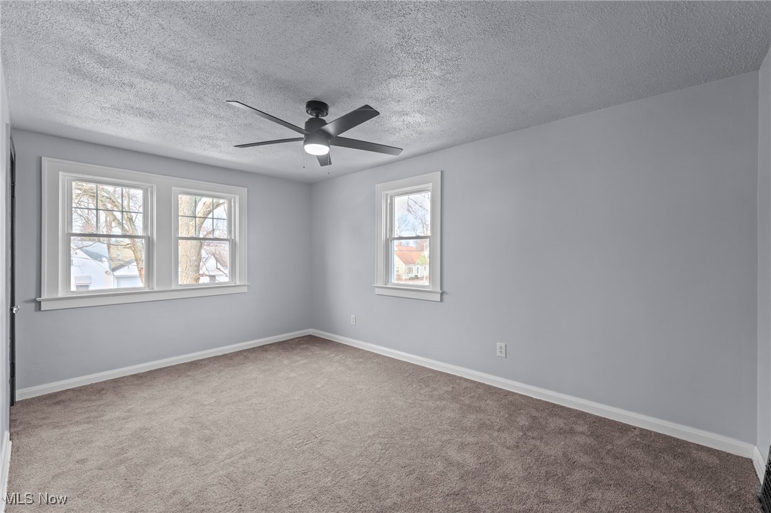 1193 Mayfield Ridge Road Cleveland, OH 44124 - Photo 25 of 35 Spare room featuring a textured ceiling, carpet floors, and ceiling fan