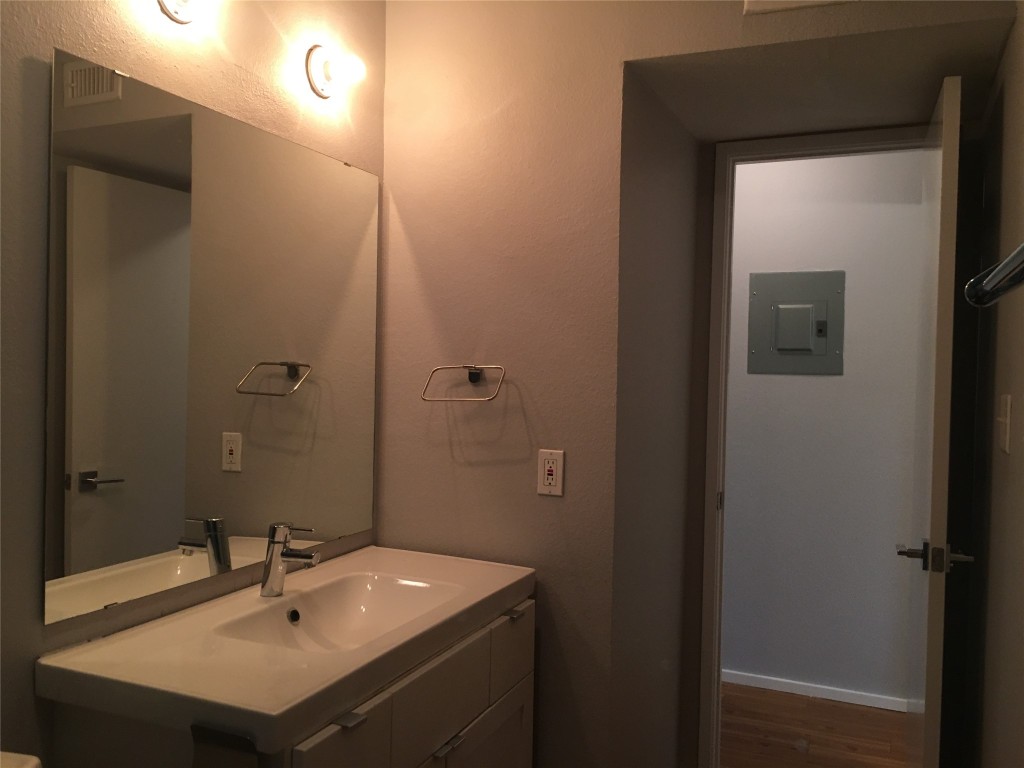5306 Woodrow Avenue, Unit 204 Austin, TX 78756 - Photo 6 of 8 Bathroom with electric panel, vanity, and dark wood-type flooring