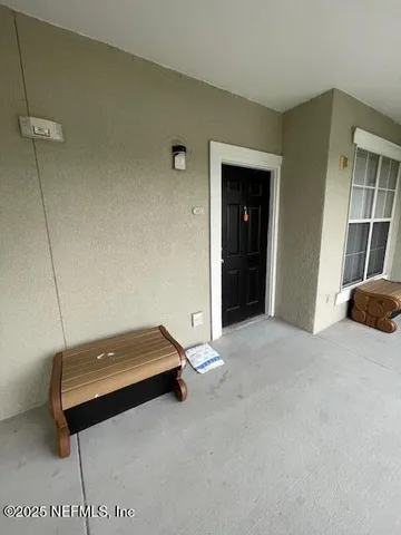 a living room with a bed and a window