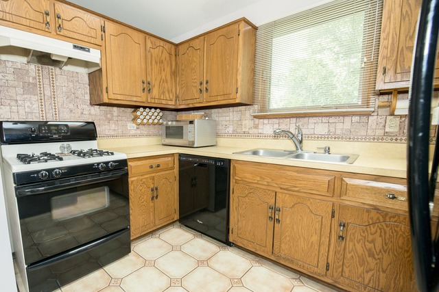 4 Wedgewood Road Matteson, IL 60443 - Photo 7 of 20 a kitchen with granite countertop white cabinets and white appliances